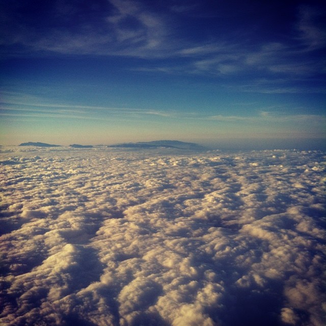 Mountains peeking through the clouds on the way to Oman